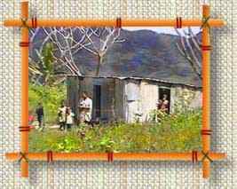 impoverished Fijian family in corrugated iron hut with dirt floor